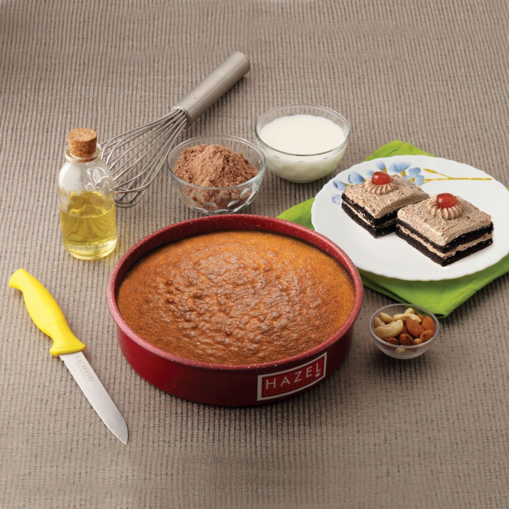 Hazel aluminium non-stick round cake mould, 8 inches in diameter and 2.5 inches deep with a red exterior, designed for baking cakes and other desserts.