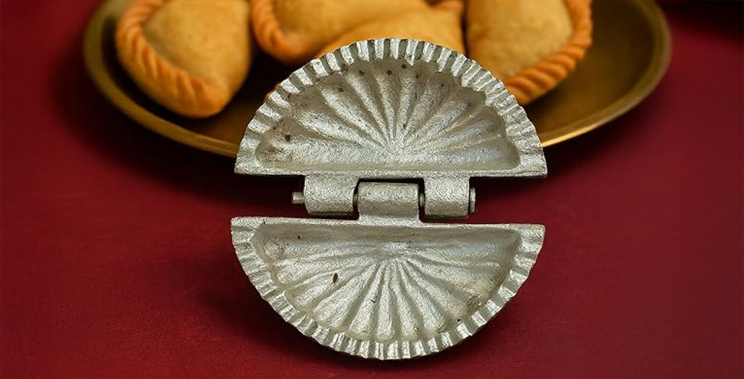Aluminum gujiya karanji maker mould for folding, pressing and sealing gujiyas, karanjis, dumplings and momos, designed for even sealing and easy use.